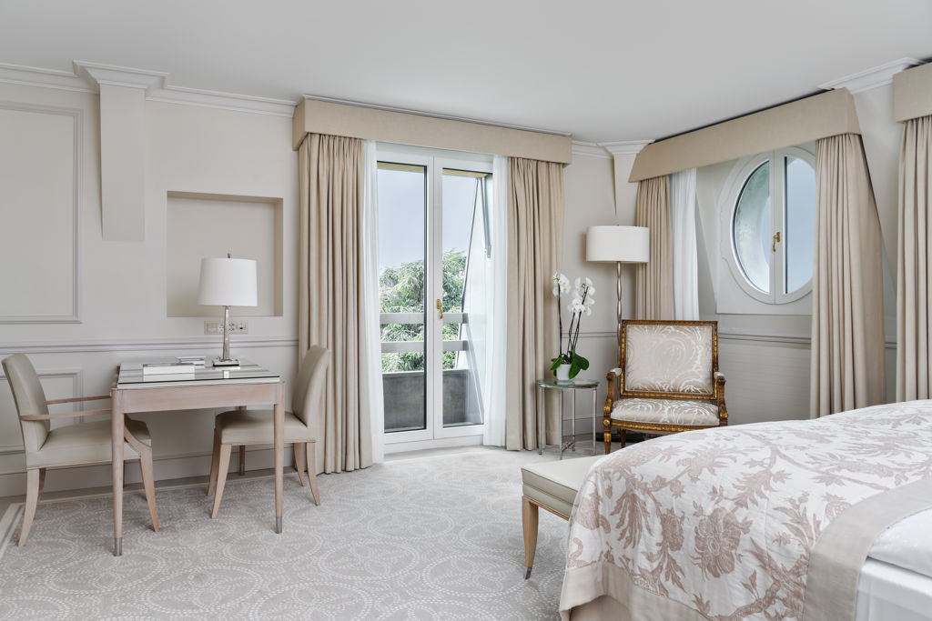 Bedroom of the Deluxe City and Garden View Room at Beau-Rivage Palace in Lausanne overlooking the gardens