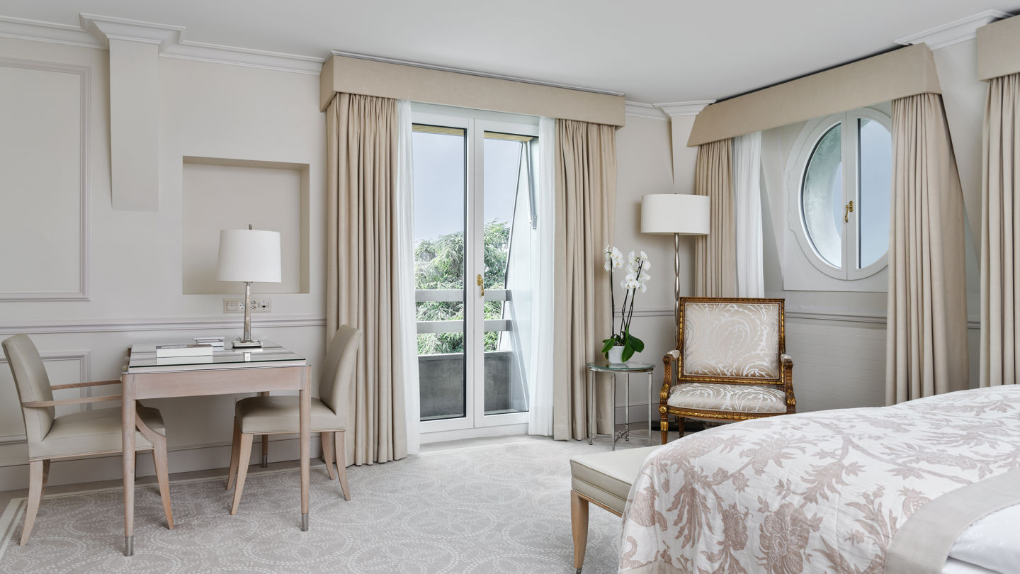 Bedroom of the Deluxe City and Garden View Room at Beau-Rivage Palace in Lausanne overlooking the gardens