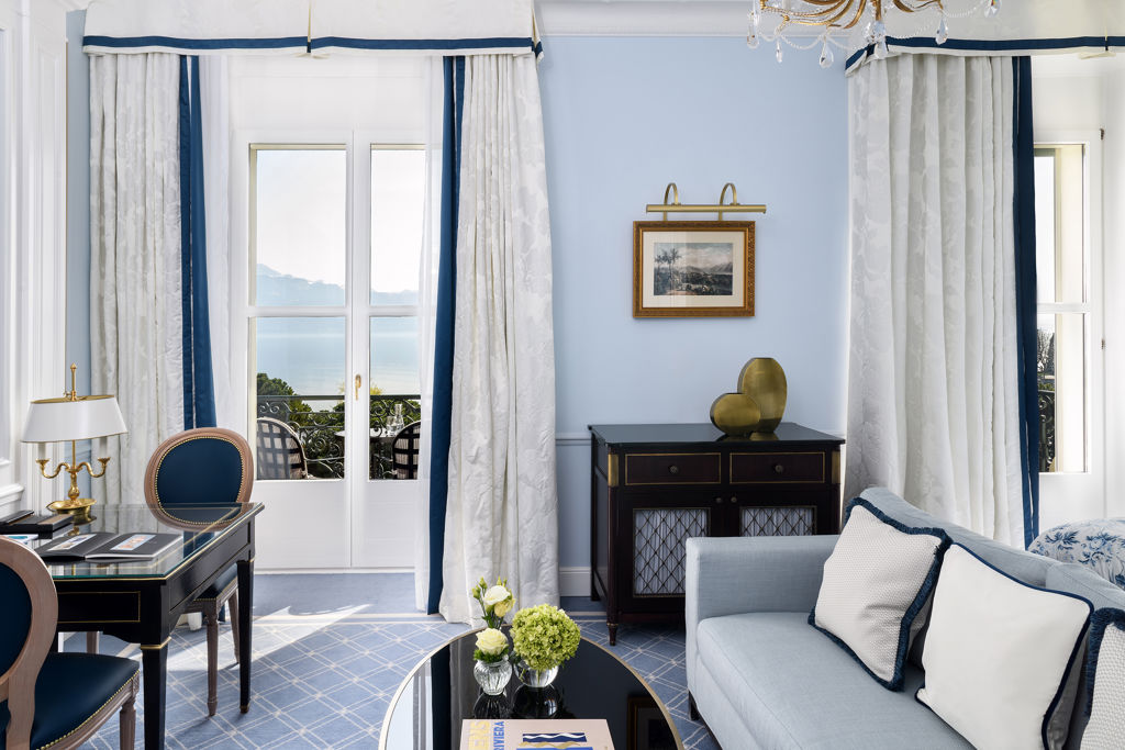 Lounge area of the Deluxe Lake and Alps View Room at Beau-Rivage Palace in Lausanne overlooking the lake and the Alps