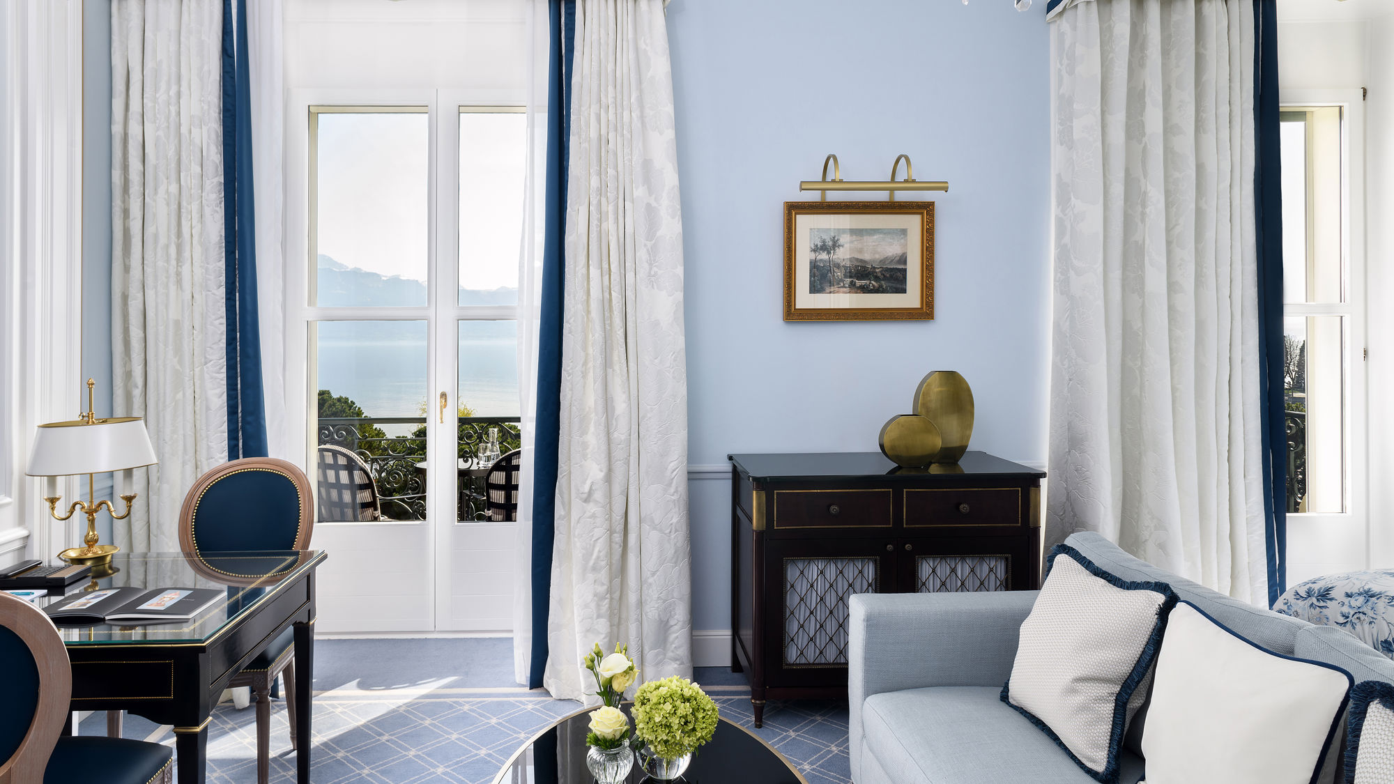 Lounge area of the Deluxe Lake and Alps View Room at Beau-Rivage Palace in Lausanne overlooking the lake and the Alps