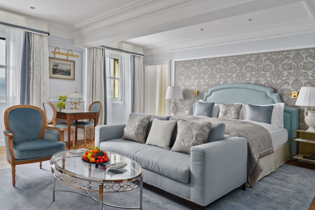 Bedroom and lounge area in the Deluxe Lake and Alps View Room at Beau-Rivage Palace in Lausanne overlooking the lake and the Alps