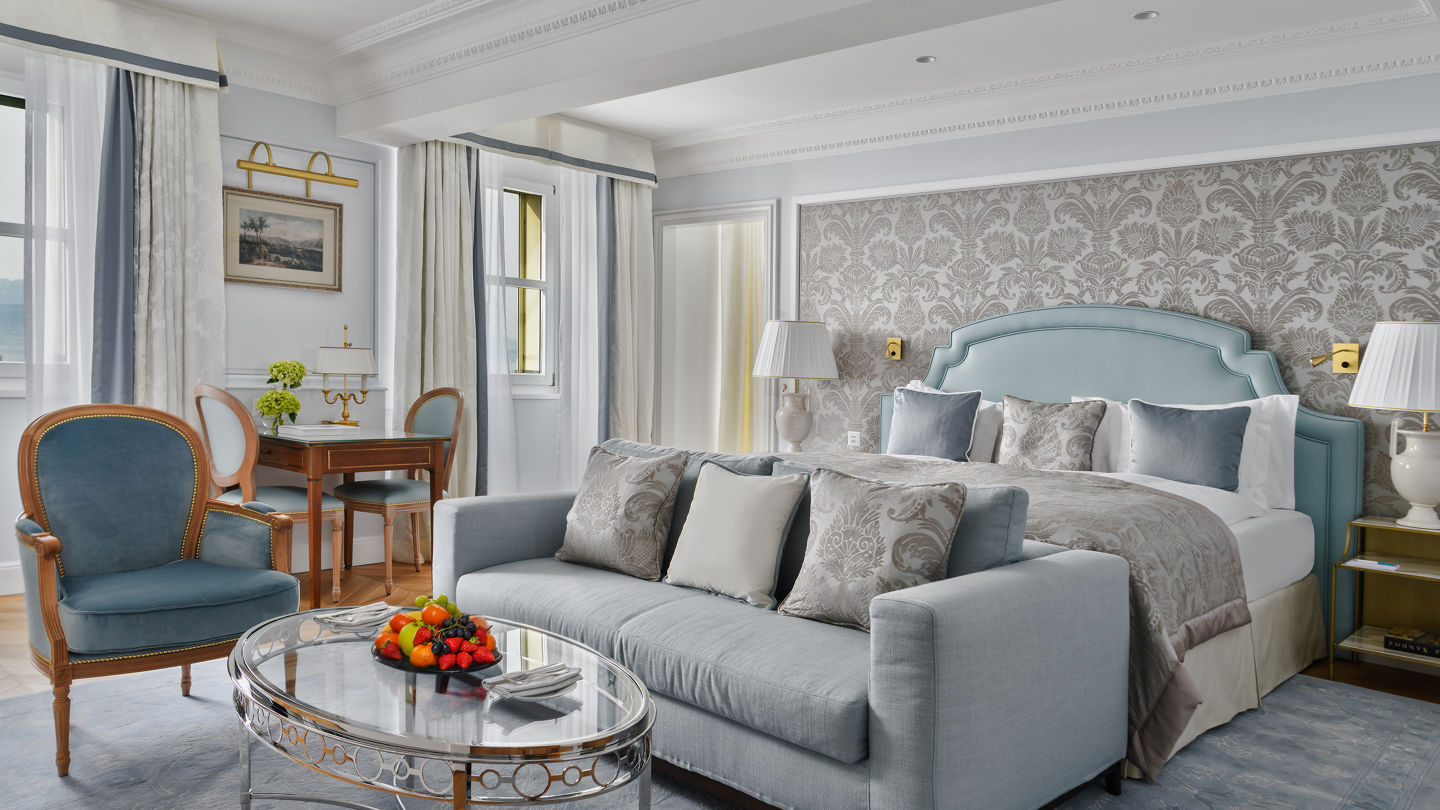 Bedroom and lounge area in the Deluxe Lake and Alps View Room at Beau-Rivage Palace in Lausanne overlooking the lake and the Alps
