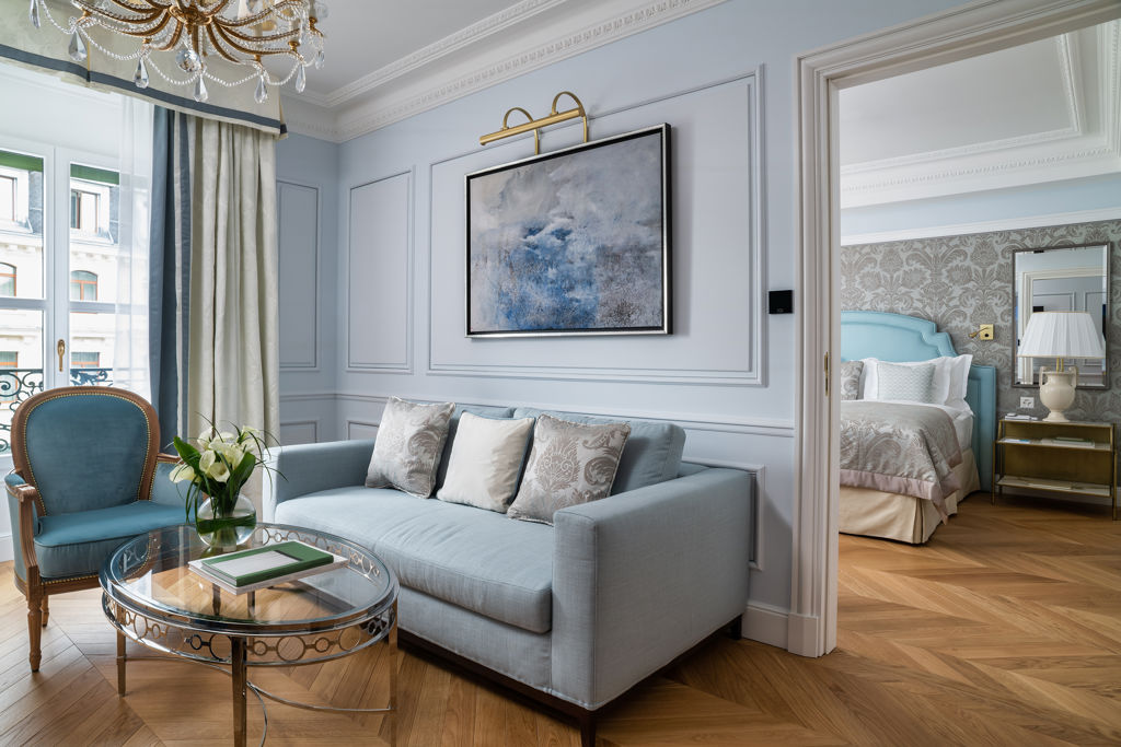 Bedroom and lounge area in the Deluxe City and Garden View Room at Beau-Rivage Palace in Lausanne