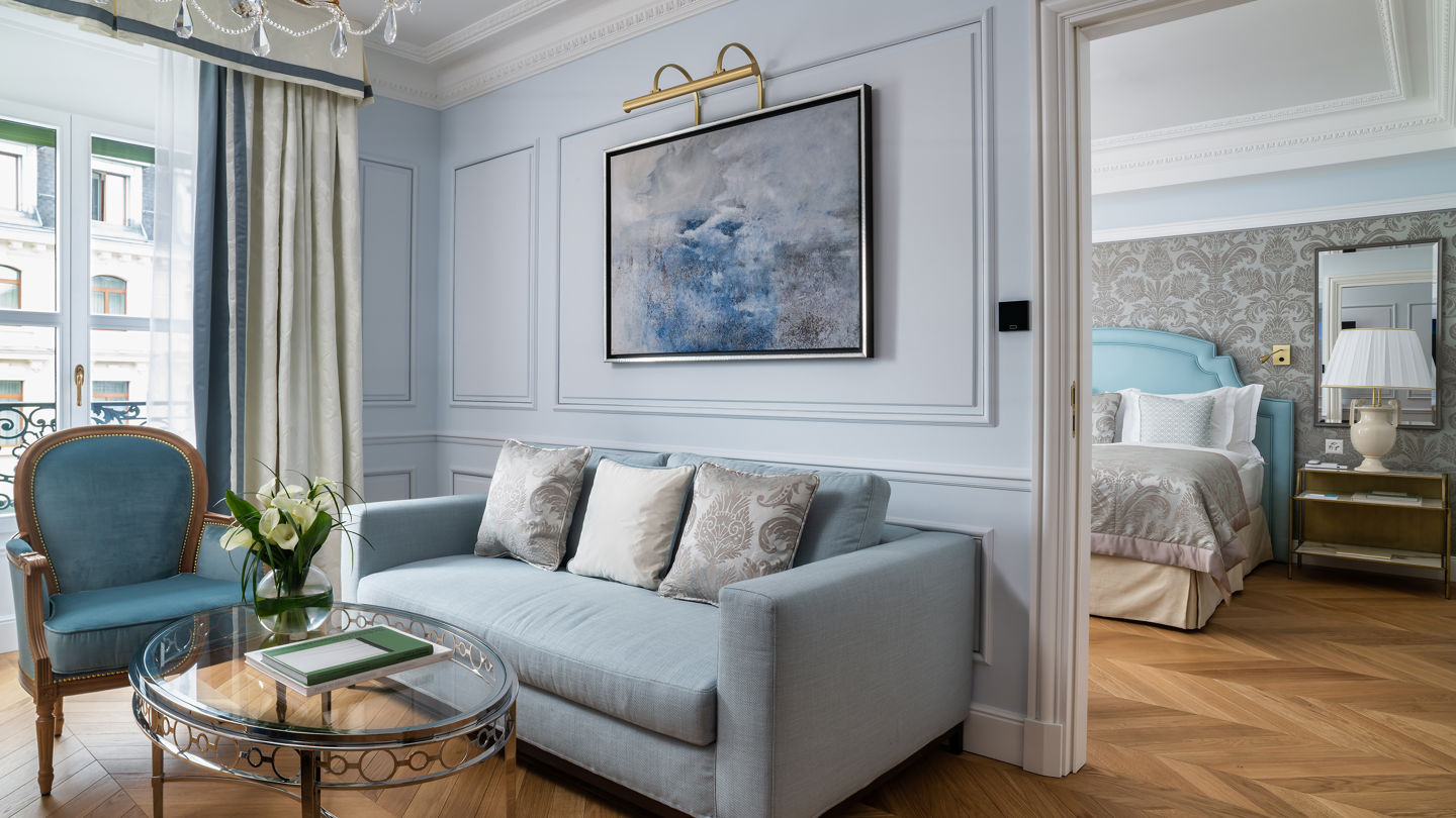 Bedroom and lounge area in the Deluxe City and Garden View Room at Beau-Rivage Palace in Lausanne