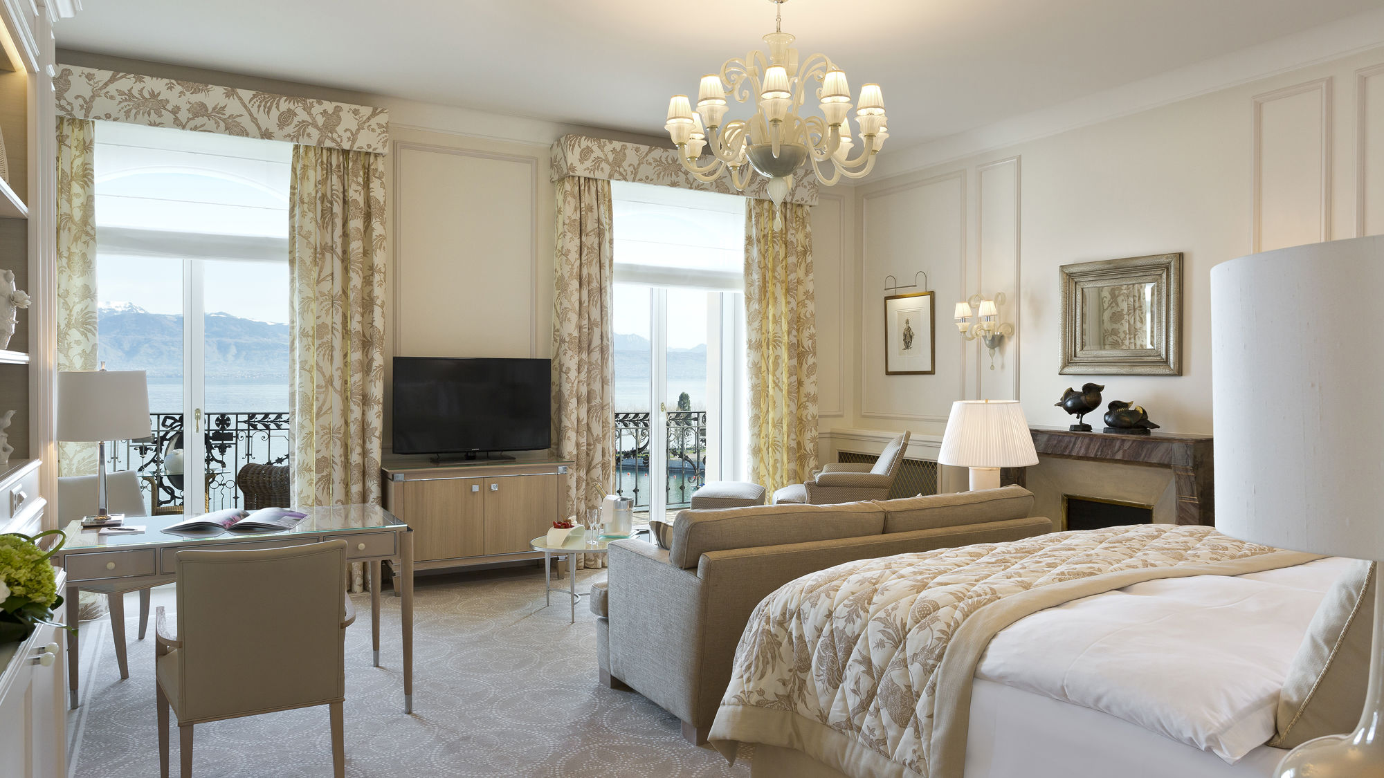 Bedroom and lounge area in the Junior Suite Palace Room at Beau-Rivage Palace in Lausanne overlooking the lake and the Alps