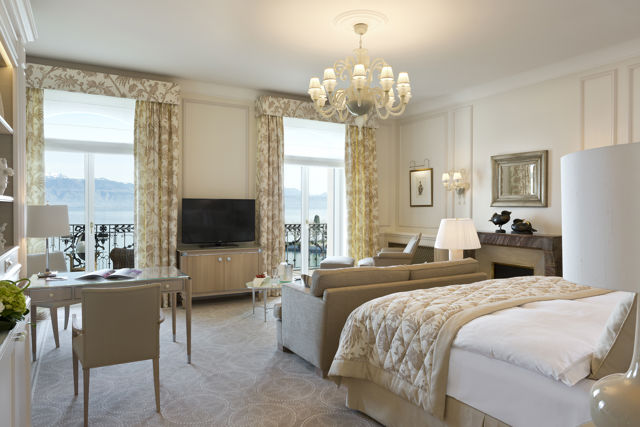 Bedroom and lounge area in the Junior Suite Palace Room at Beau-Rivage Palace in Lausanne overlooking the lake and the Alps