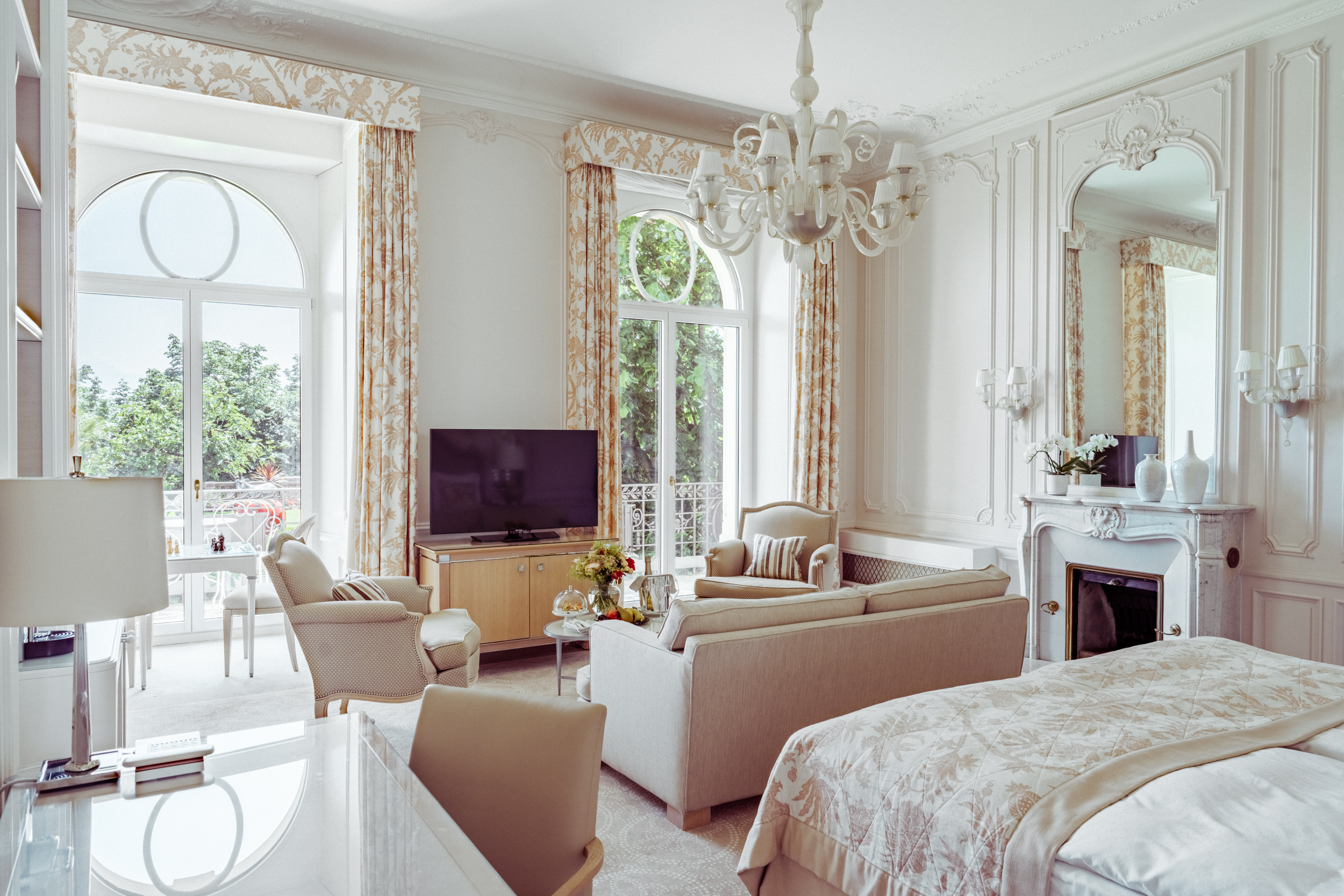 Bedroom and lounge area in the Junior Suite Palace Ground Floor Room at Beau-Rivage Palace in Lausanne overlooking the gardens, the lake and the Alps