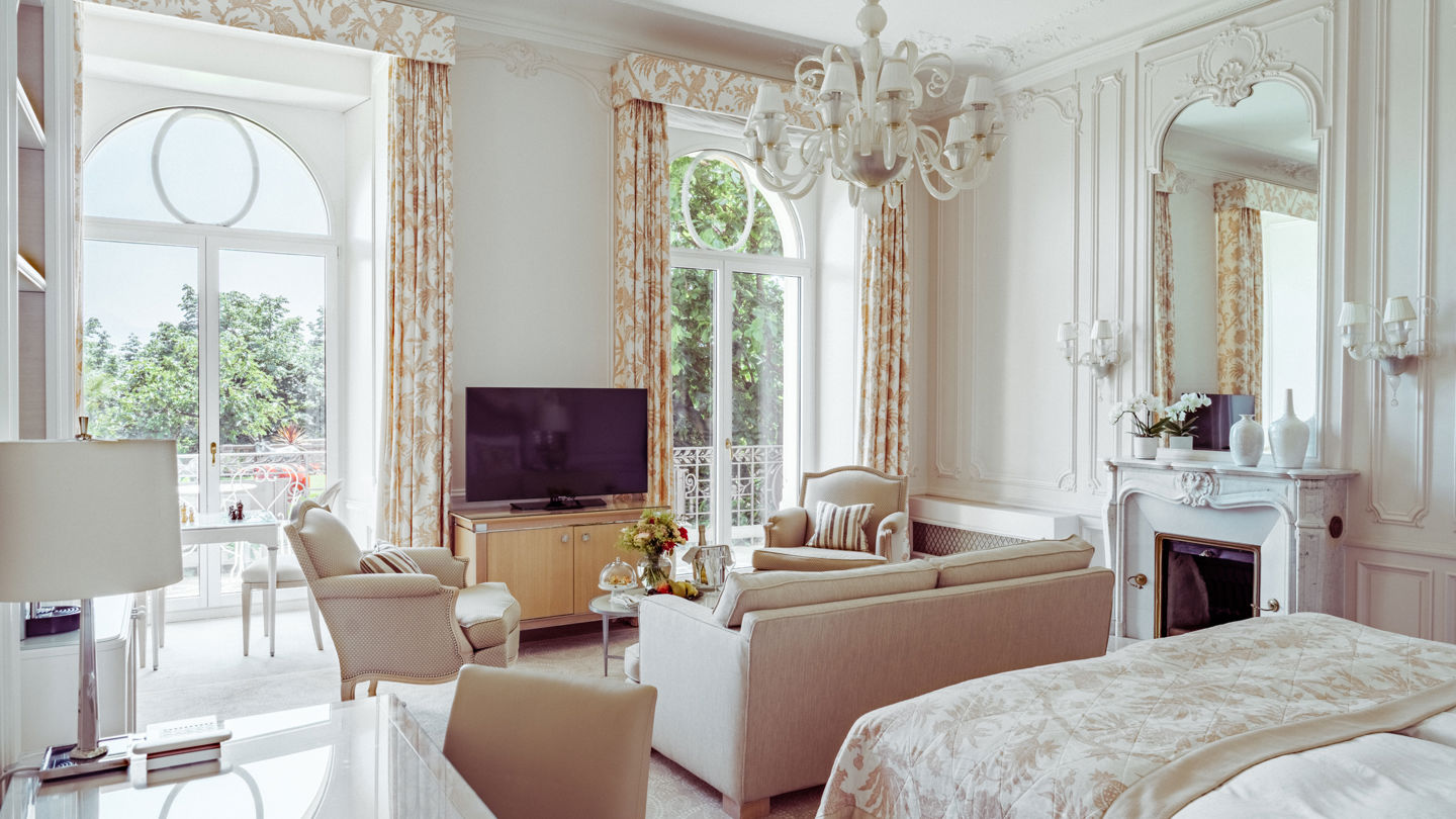Bedroom and lounge area in the Junior Suite Palace Ground Floor Room at Beau-Rivage Palace in Lausanne overlooking the gardens, the lake and the Alps