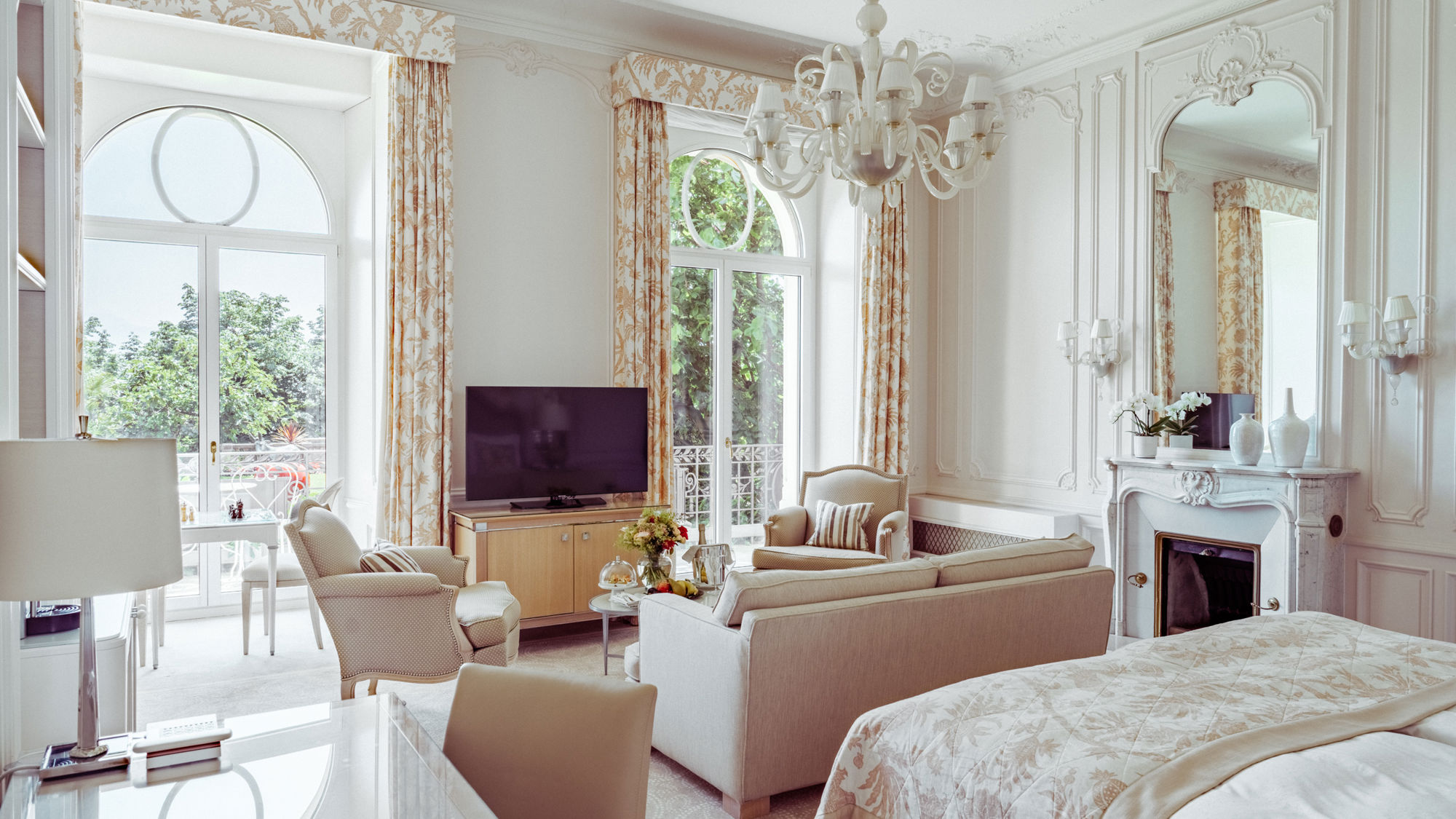Bedroom and lounge area in the Junior Suite Palace Ground Floor Room at Beau-Rivage Palace in Lausanne overlooking the gardens, the lake and the Alps