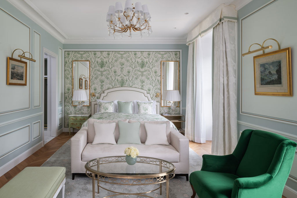 Bedroom and lounge area in the Deluxe City and Garden View Room at Beau-Rivage Palace in Lausanne