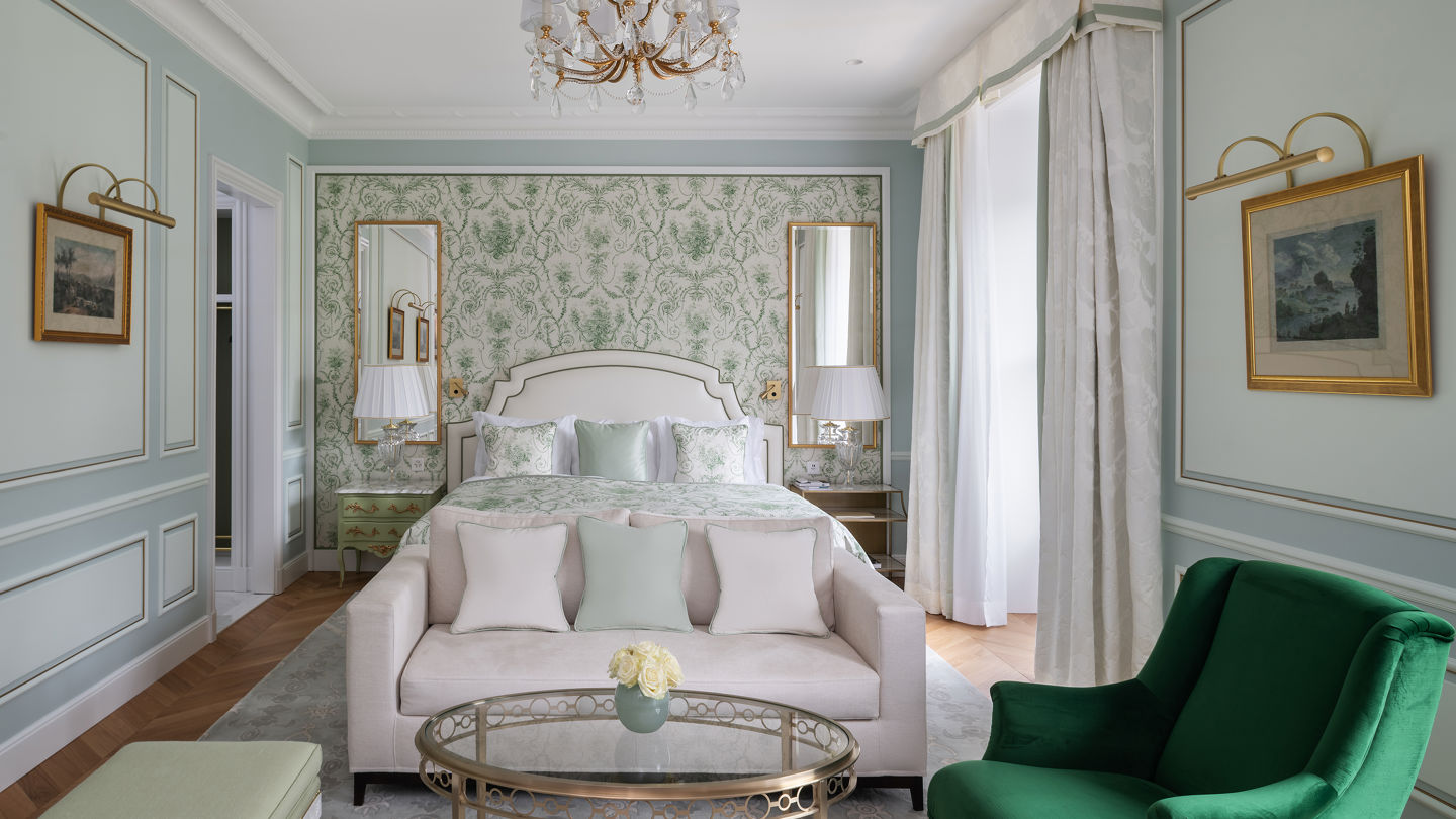 Bedroom and lounge area in the Deluxe City and Garden View Room at Beau-Rivage Palace in Lausanne