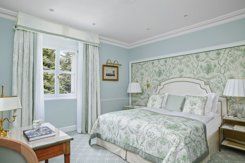 Bedroom of the Deluxe City and Garden View Room at Beau-Rivage Palace in Lausanne overlooking the gardens