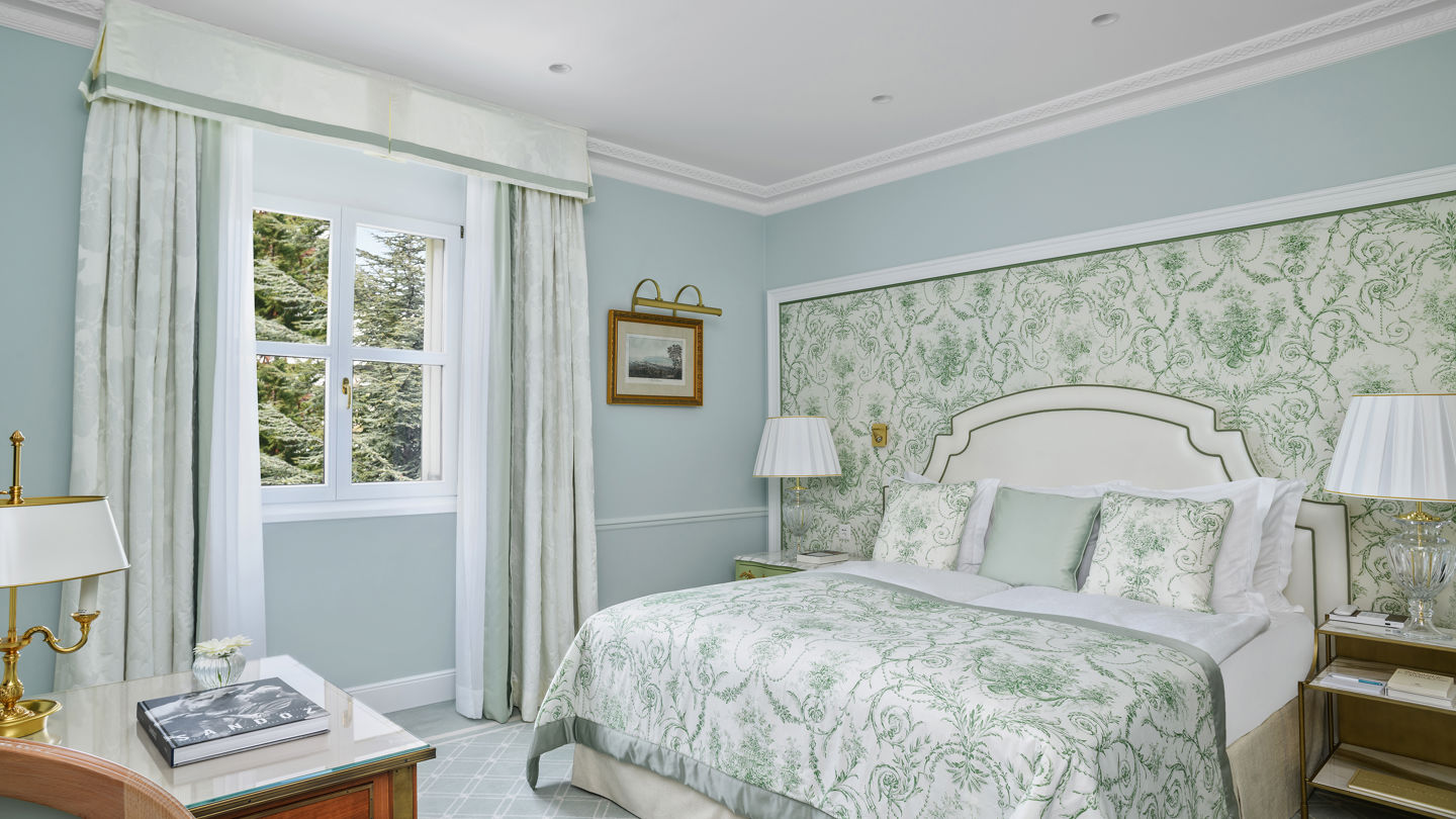 Bedroom of the Deluxe City and Garden View Room at Beau-Rivage Palace in Lausanne overlooking the gardens