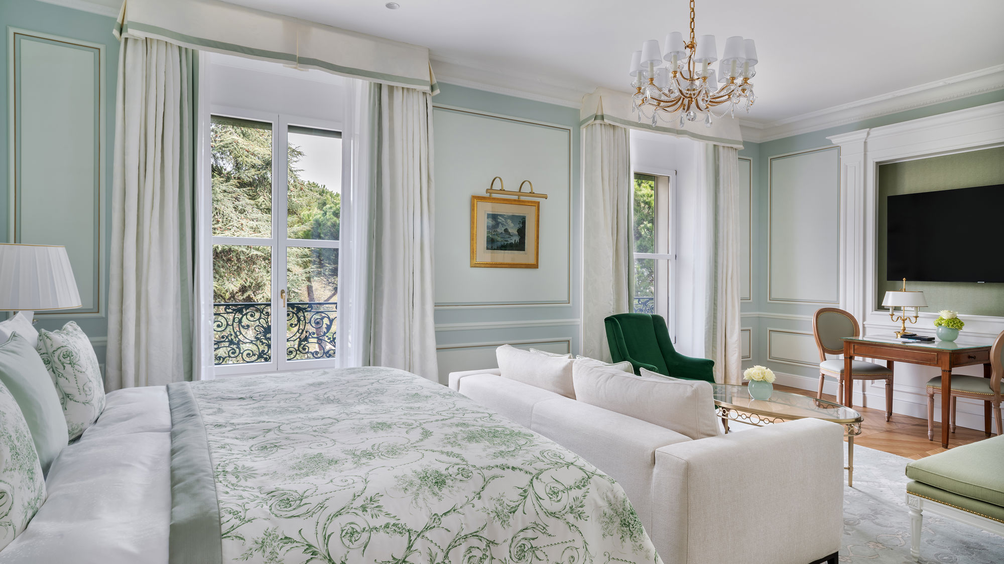 Bedroom and lounge area in the Deluxe City and Garden View Room at Beau-Rivage Palace in Lausanne overlooking the gardens