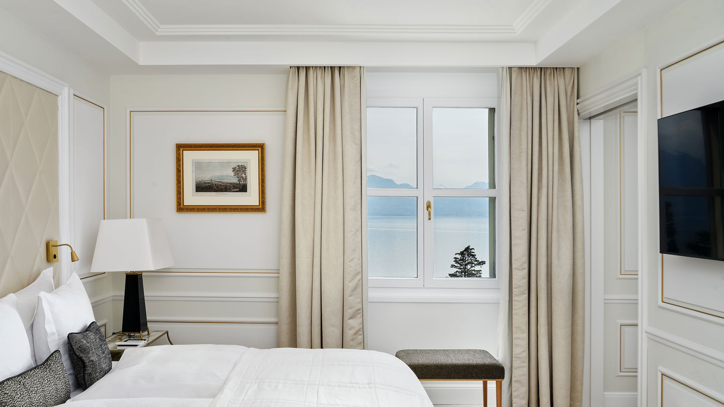 Bedroom of the Deluxe Riviera Room at Beau-Rivage Palace in Lausanne overlooking the lake and the Alps